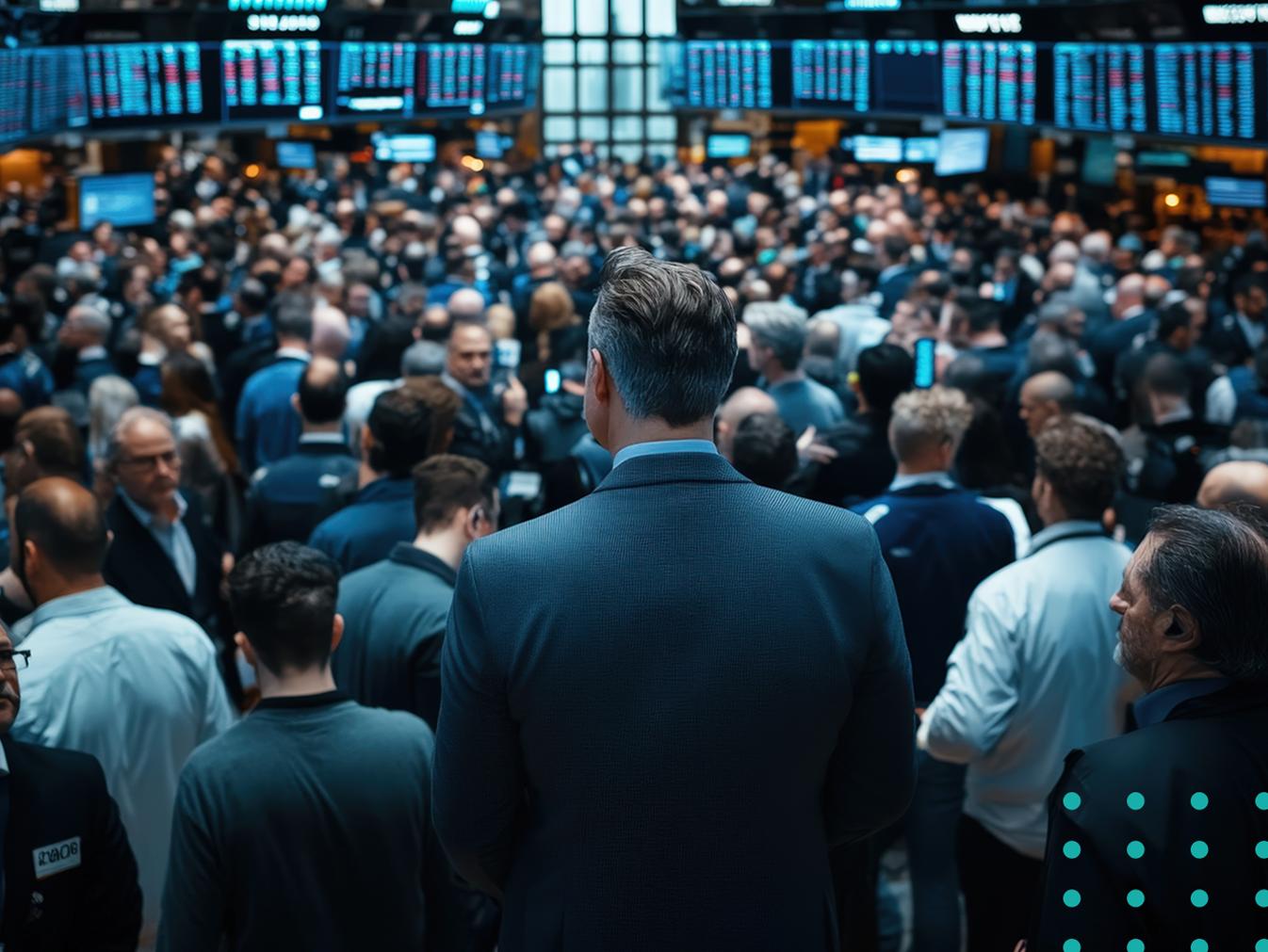 man looking out on trading floor at a stock exchange