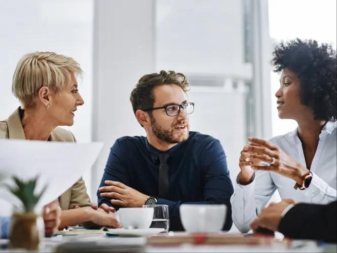 Three business professionals having a conversation
